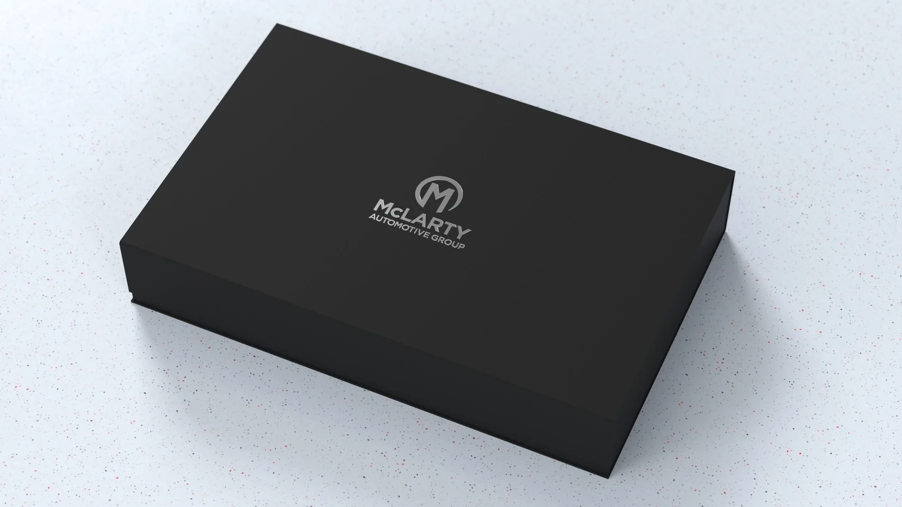 Matte black McLarty gift box with foil-stamped logo