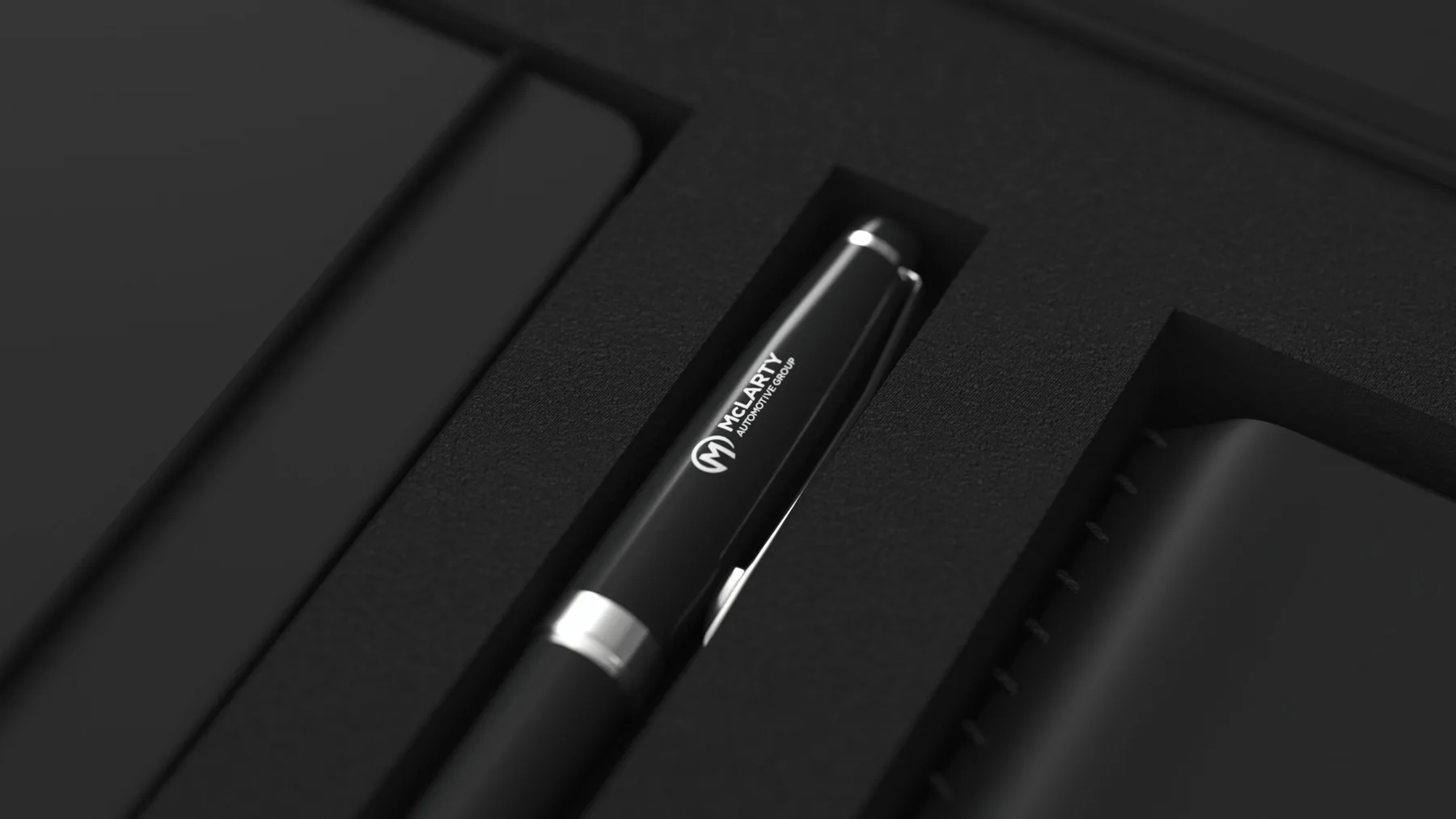 Close-up of the McLarty Automotive Group branded pen